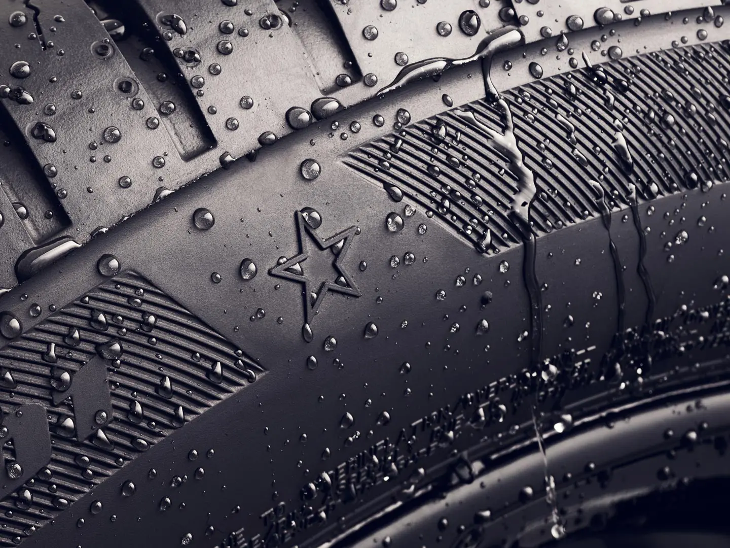 Detailný záber bočnej steny pneumatiky so zobrazením symbolu hviezdičky, čo znamená, že pneumatika je schválená na dosiahnutie optimálneho výkonu vozidiel MINI. 